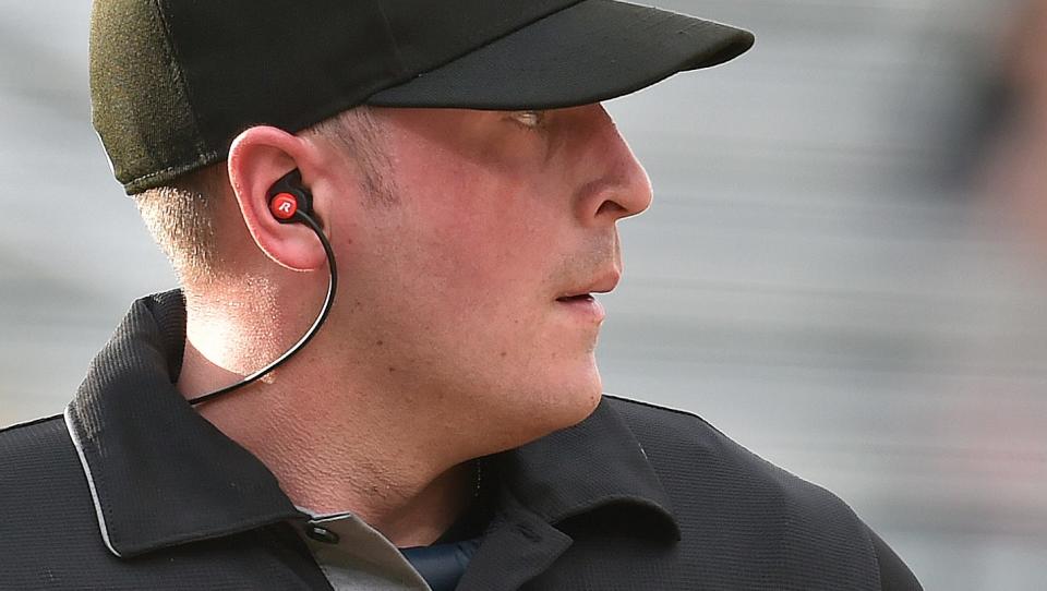 Home-plate umpire Nelson Fraley wore an earpiece working Wednesday night's Bradenton-Tampa Florida State League game. Through the earpiece, Fraley received ball and strike calls from a computer.