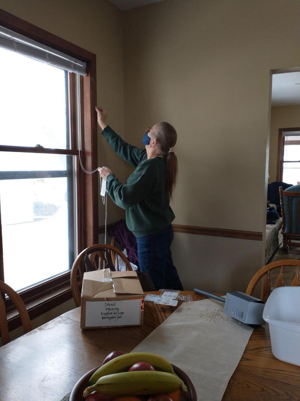 Jill Trentlage of Combined Locks helps prepare a house for a family from Afghanistan as part of Christ the King's Good Neighbor Team.