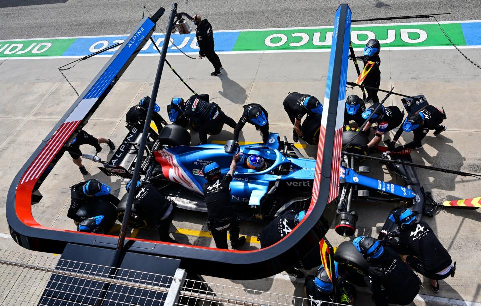 Alpine's mechanics work on the car of Alpine's Spanish driver Fernando Alonso in the pit lane during a practice session at the Autodromo Internazionale Enzo e Dino Ferrari race track in Imola, Italy, on April 17, 2021, on the eve of the Formula One Emilia Romagna Grand Prix. (Photo by MIGUEL MEDINA / AFP) (Photo by MIGUEL MEDINA/AFP via Getty Images)