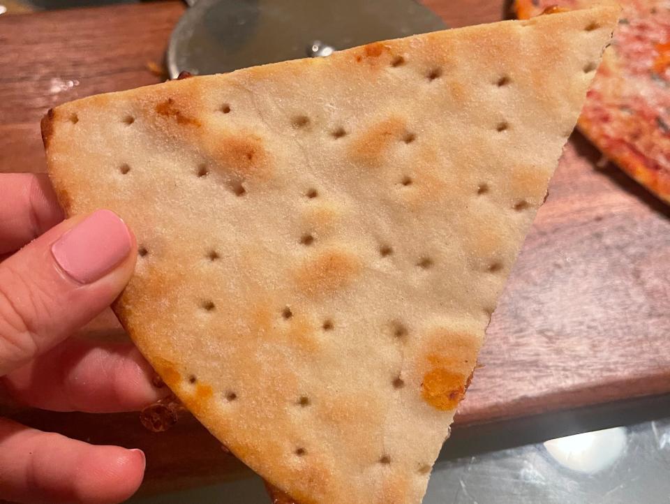 Golden-brown underside of baked pizza