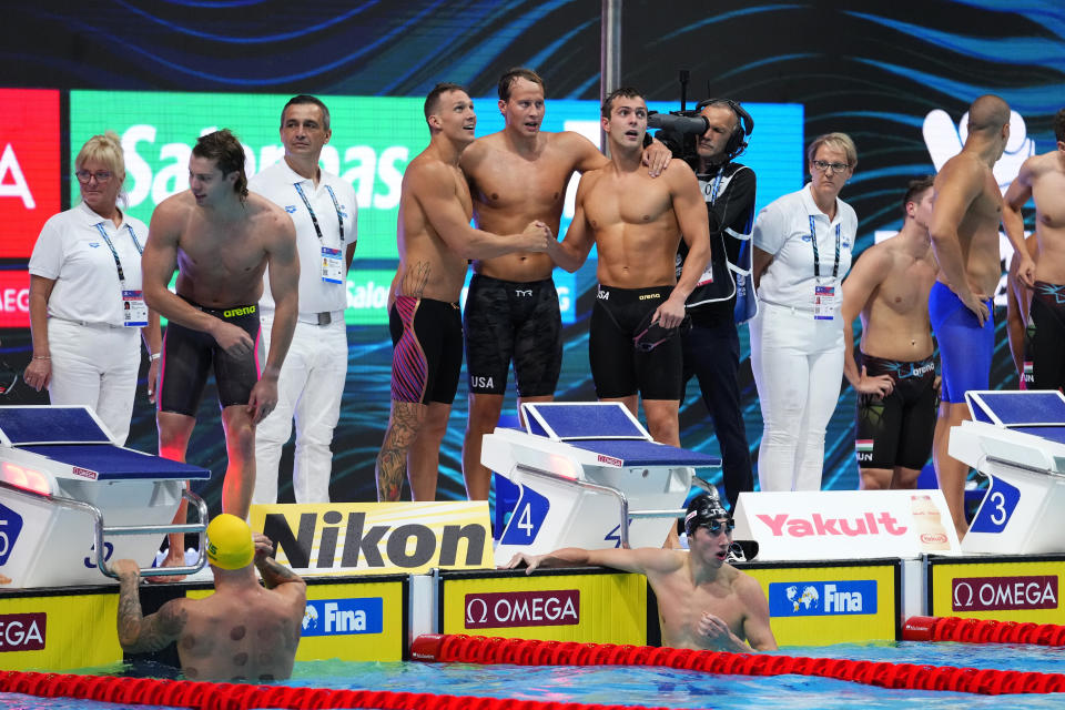 Members of team United States celebrate after winning the men's 4x100m freestyle relay final at the 19th FINA World Championships in Budapest, Hungary, Saturday, June 18, 2022. (AP Photo/Petr David Josek)