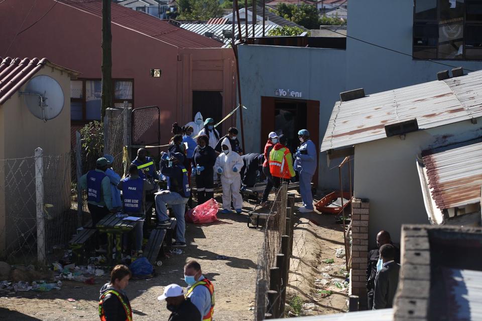 South African Police Forces (SAPS) and forensics experts work at the scene where an estimated 20 young people died in Enyobeni Tavern in East London, South Africa