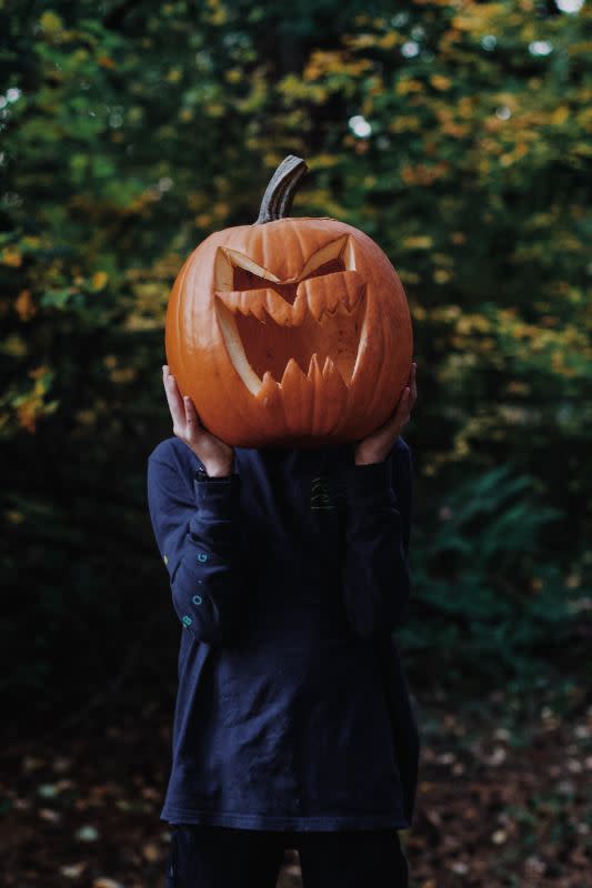 <p>Zach Lezniewicz/Unsplash</p><p>Whether you cut out a hole on the bottom to wear as a real mask, or you just make a terrifying jack-o'-lantern face, this type of pumpkin carving is a classic for a reason. </p>