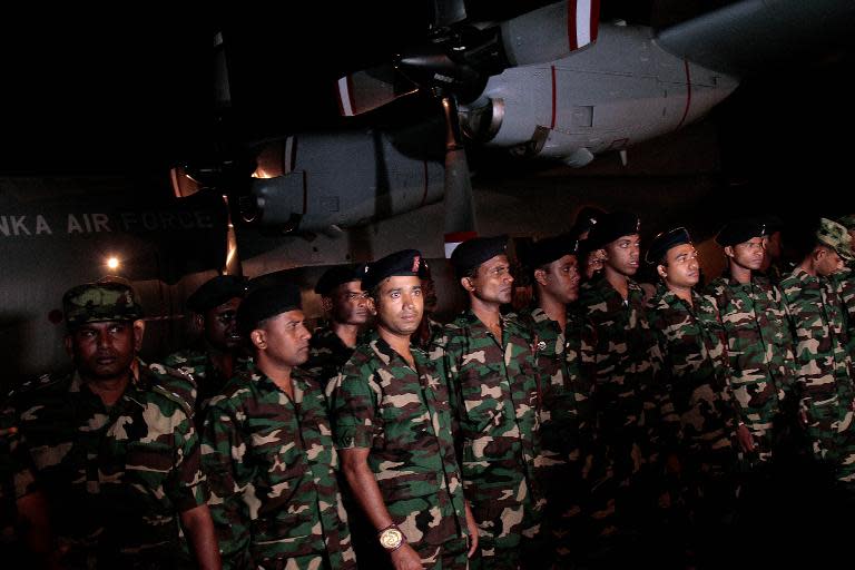 Sri Lankan soldiers prepare to fly to Nepal from the main international airport in Katunayake