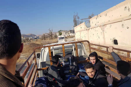 People ride in a vehicle as they are evacuated from the town of Douma, eastern Ghouta, in Damascus, Syria April 1, 2018. REUTERS/Bassam Khabieh