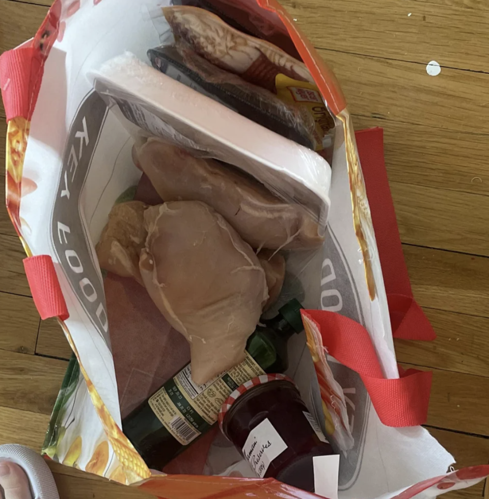 chicken out of its plastic package and spilled on the rest of the groceries