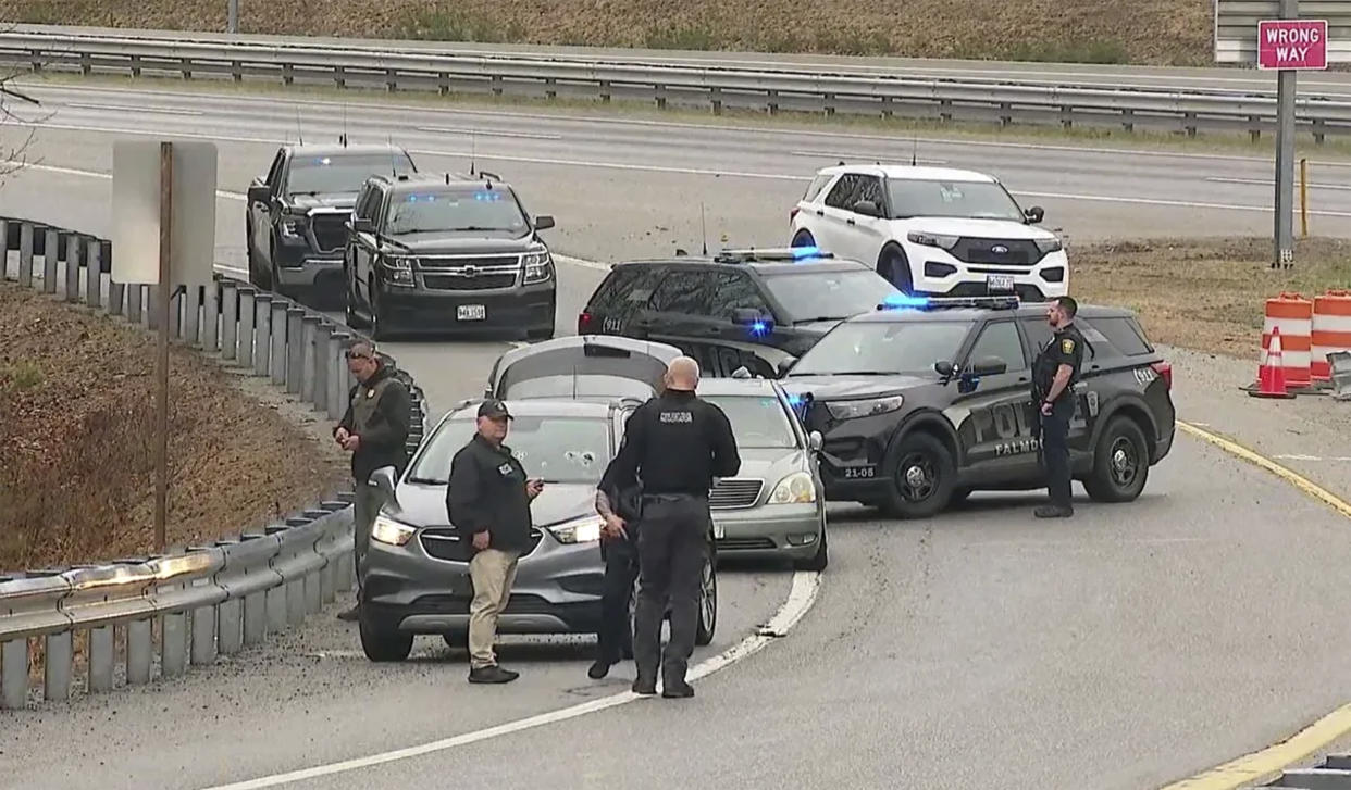 In this image taken video, members of law enforcement investigate a scene where people were injured in a shooting on Interstate 295 in Yarmouth, Maine, Tuesday, April 18, 2023. (WGME-TV via AP)