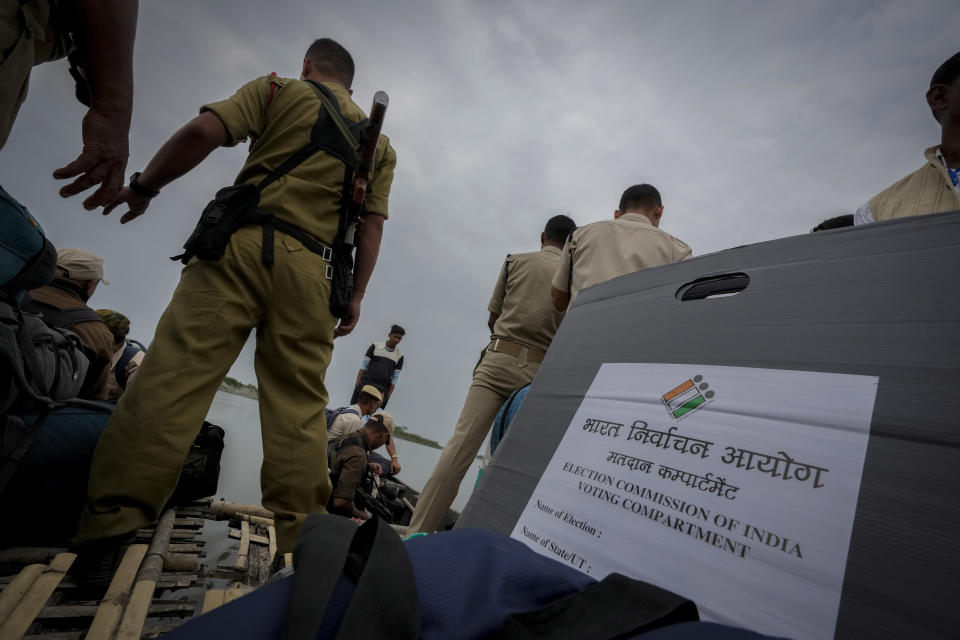 Polling officials and security personnel headed to a remote polling booth travel on a boat to cross the river Brahmaputra on the eve of parliament election at Baghmora Chapori (small island) of Majuli, northeastern Assam, India, April 18, 2024. (AP Photo/Anupam Nath)