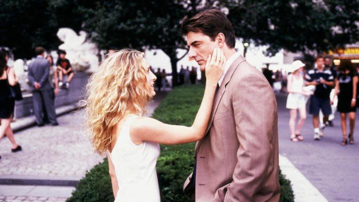 Sarah Jessica Parker and Chris Noth as Carrie and Big facing each other while standing in a park in Sex and the City.