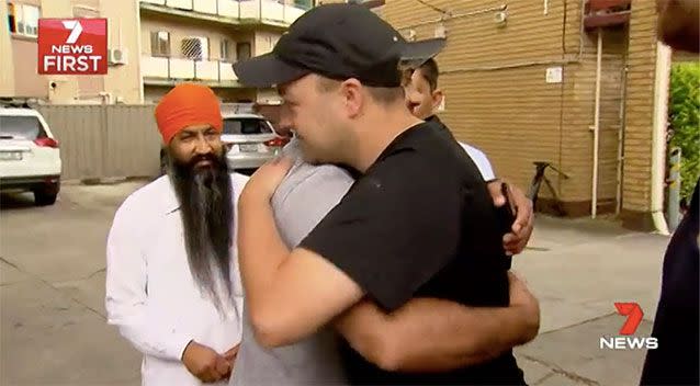 The nephew of an Adelaide man fatally struck by a taxi hugs the men who tried to save his life at the scene. Picture: 7 News