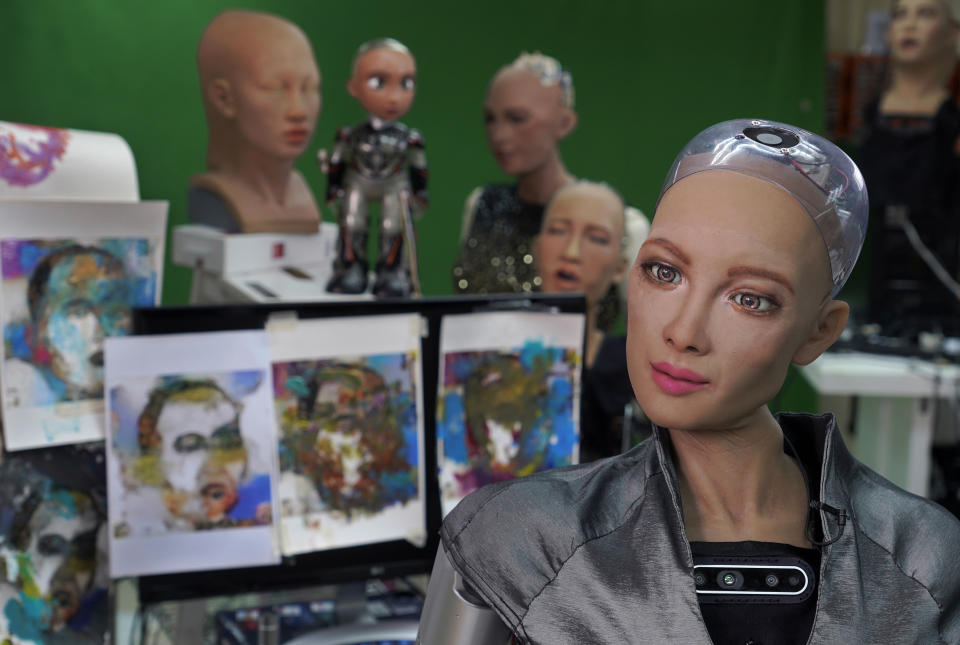 Sophia answers questions at Hanson Robotics studio in Hong Kong on March 29, 2021. Sophia is a robot of many talents — she speaks, jokes, sings and even makes art. In March, she caused a stir in the art world when a digital work she created as part of a collaboration was sold at an auction for $688,888 in the form of a non-fungible token (NFT). (AP Photo/Vincent Yu)