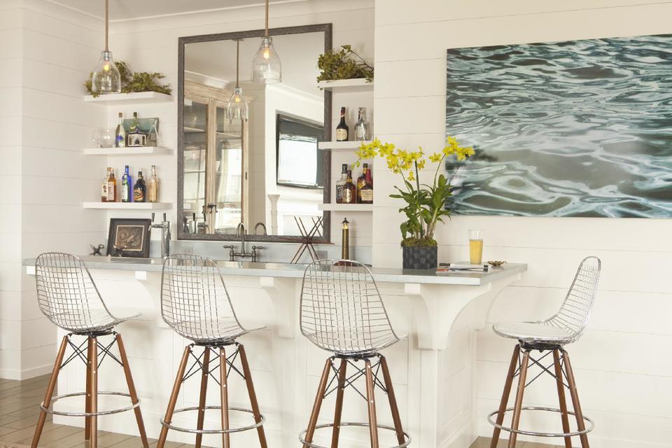 This interior design image released by Lucas Studio, Inc. shows a bar with a beach inspired design. The sun-drenched colors and windswept beachfront textures of summer provide ample inspiration for indoor decorating. Done wrong, a summer-inspired interior can be a tacky, overly tropical disaster. But with a light touch and careful choices, summer can provide ideas for an interior you'll love all year long. (AP Photo/Lucas Studio, Inc., Karyn Millet)