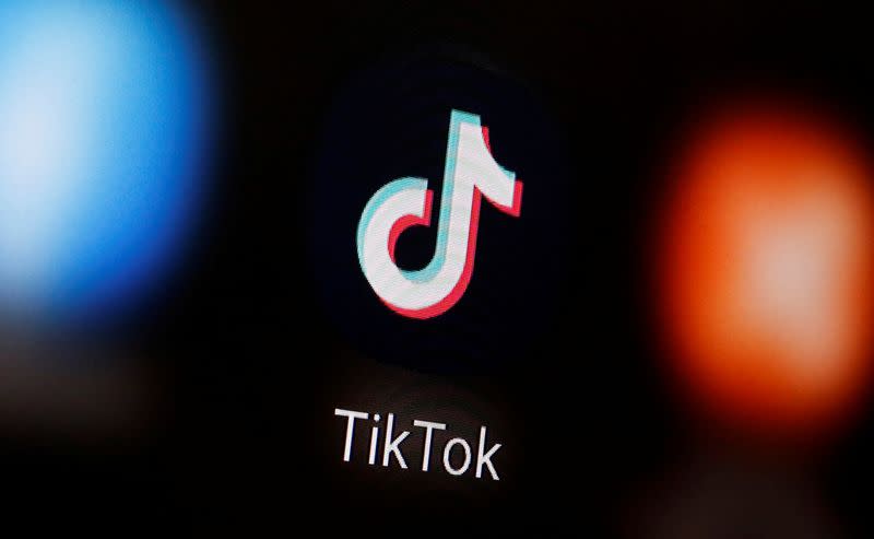 A TikTok logo is displayed on a smartphone in this illustration