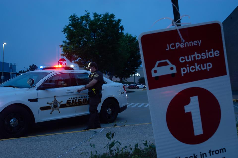 A Vanderburgh County Sheriff's Office deputy prepares to enter his squad car outside the Eastland Mall's JCPenney on Saturday, May 13, 2023. A large fight reportedly broke out just after 6 p.m. and led to fears of a potential active shooter, triggering an intense law enforcement response.