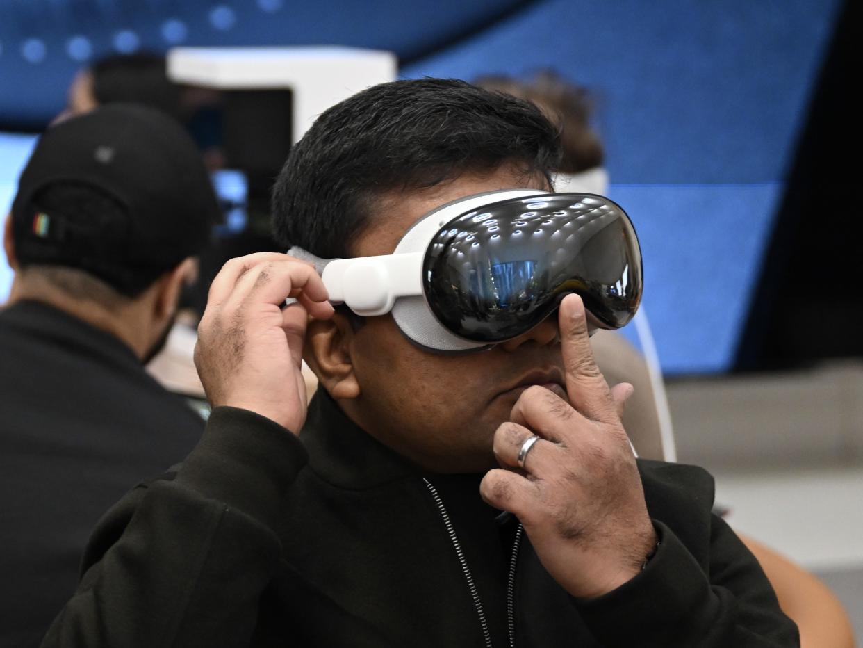 A man trying on the Apple Vision Pro at an Apple Store.