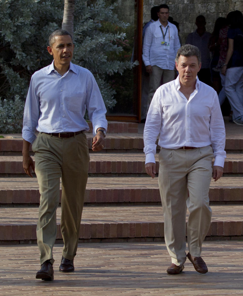 President Barack Obama, left, and Colombian President Juan Manuel Santos arrive to attend a joint news conference during the 6th Summit of the Americas in Cartagena, Colombia, Sunday, April 15, 2012. (AP Photo/Carolyn Kaster)