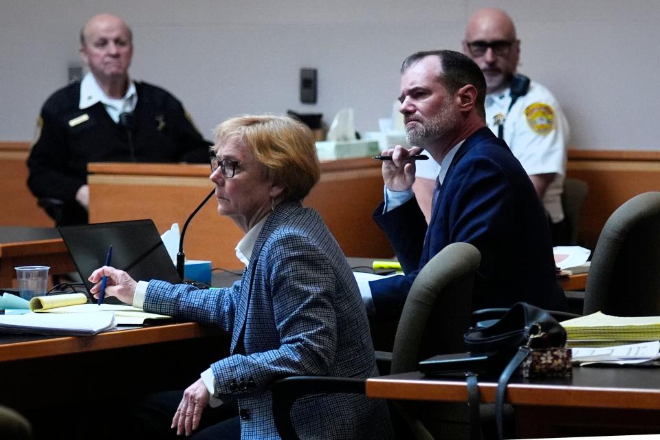 Defense attorneys James Brooks, right, and Caroline Smith listen to the prosecution address the court during the trial of the Adam Montgomery at Hillsborough County Superior Court, Tuesday, Feb. 20, 2024, in Manchester, N.H. Montgomery is facing second-degree murder and other charges in the death of his daughter, Harmony. (AP Photo/Charles Krupa, Pool)