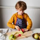 This product image shows a child using the Opinel’s Le Petit Chef knife set, which received high marks from the folks at America’s Test Kitchen. There are built-in finger rings on the knife and peeler to help kids learn proper holds, as well as a plastic finger guard. (Opinel via AP)