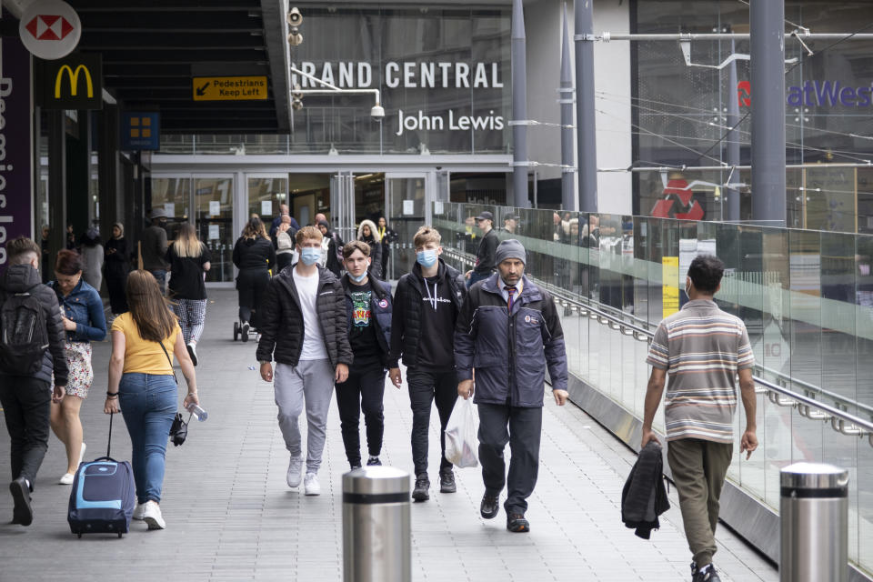 With most shops now open but with retail sales suffering due to the Coronavirus pandemic, young men wearing face masks, which became compulsory in shops on the 24th July, walk down the ramp outside John Lewis in the city centre on 5th August 2020 in Birmingham, United Kingdom. Coronavirus or Covid-19 is a respiratory illness that has not previously been seen in humans. While much or Europe has been placed into lockdown, the UK government has put in place more stringent rules as part of their long term strategy, and in particular social distancing. (photo by Mike Kemp/In PIctures via Getty Images)