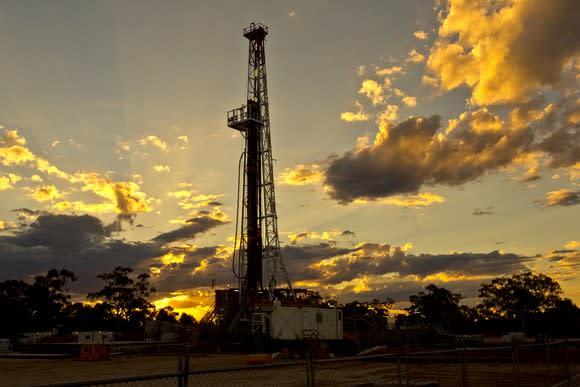 Land drilling rig at sunset.