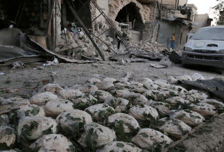 Stacks of bread are seen at a damaged site after an airstrike in the rebel-held Bab al-Maqam neighbourhood of Aleppo, Syria, September 28, 2016. REUTERS/Abdalrhman Ismail