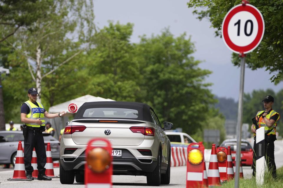 FILE - Police officers stop cars at a checkpoint near the Austrian and German border in Mittenwald, Germany, Wednesday, June 22, 2022. The G7 summit takes place in castle 'Elmau' near Garmisch-Partenkirchen from June 26 until June 28, 2022. Three back-to-back summits over the next week will test Western resolve to support Ukraine and the extent of international unity as rising geopolitical tensions and economic pain cast an increasingly long shadow. (AP Photo/Matthias Schrader, File)