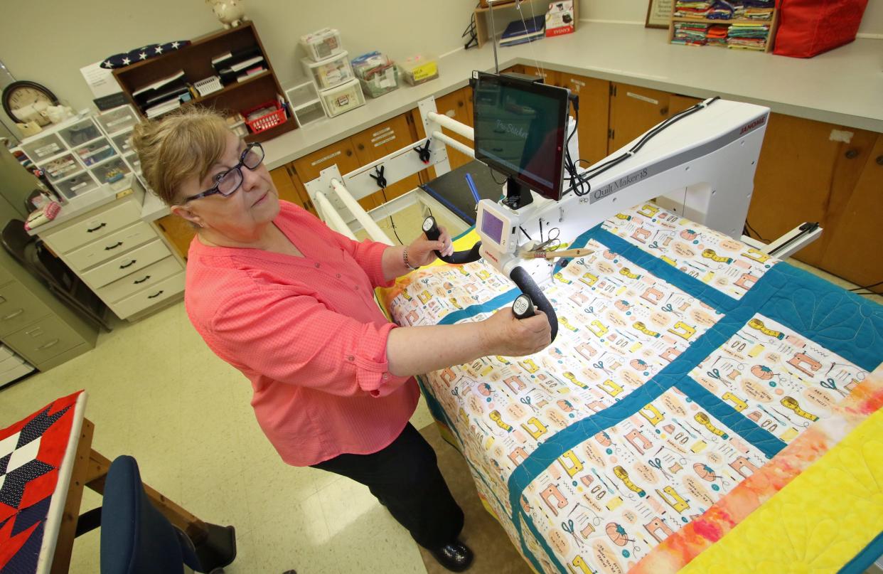 ECA volunteer Patti Wells shows off the Quilt Maker 18 at the Lucile Tatum Center on Osceola Street Tuesday afternoon, Feb. 6, 2024.