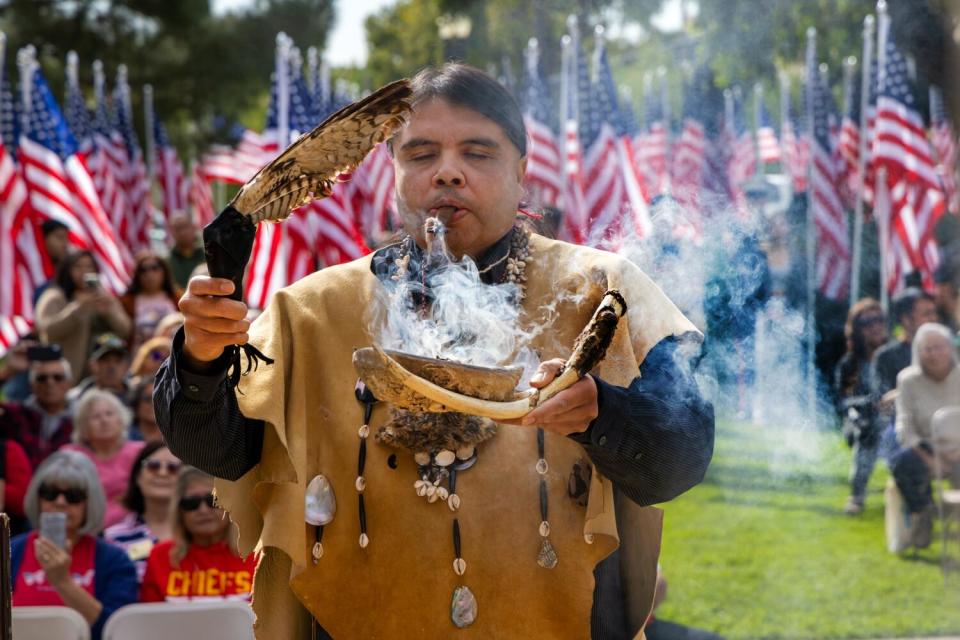 Andrew Guiding Young Cloud Morales offers a blessing during a Veterans Day ceremony.