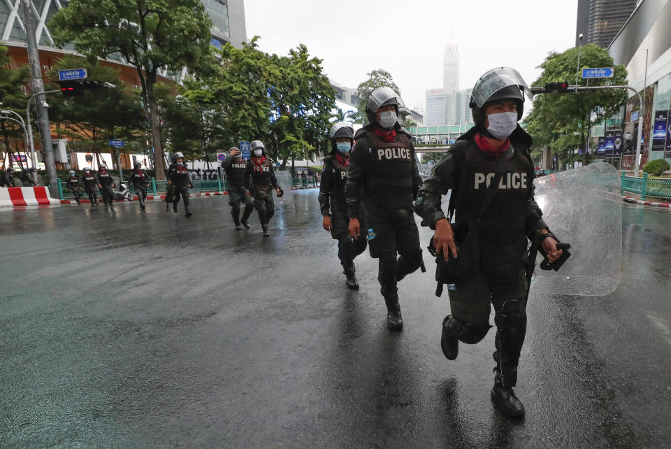 Thai police with riot shields take position in a business district where anti-government protesters sayid they will meet in Bangkok, Thailand, Friday, Oct. 16, 2020. Police announced Friday they would block roads leading to Bangkok’s Rajprasong intersection, where Thursday's rally was held, after protesters called on supporters to mass again. (AP Photo/Sakchai Lalit)