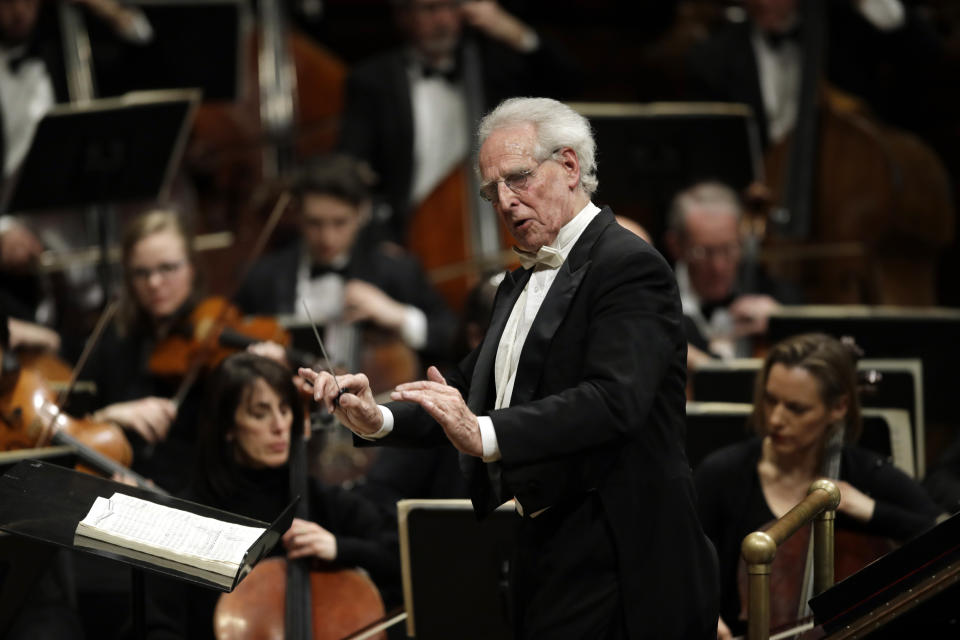In this Feb. 14, 2019 photo, Benjamin Zander conducts the Boston Philharmonic Orchestra at the Sanders Theatre in Cambridge, Mass. The internationally acclaimed conductor, who approaches his 80th birthday on March 9, has spent half his life leading the Boston Philharmonic Orchestra, which he founded in 1979. (AP Photo/Elise Amendola)