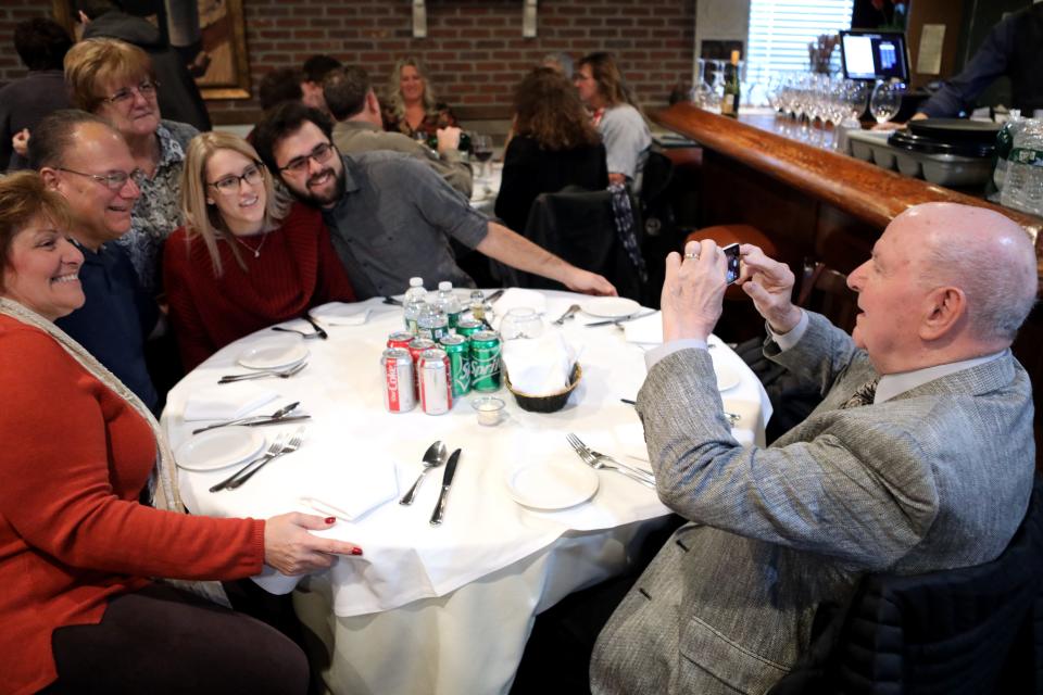 Charles Cassata, 93, WWII US Navy veteran, of Pompton Plains, takes a picture of his family with his smart phone, at 202 Italian Bistro. Approximately 200 veterans and their family members were treated to a free meal at the Lincoln Park restaurant on Thanksgiving.  Thursday, November 28, 2019