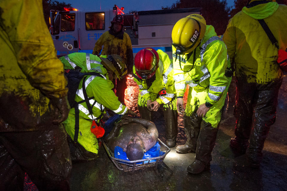 <p>Emergency personnel carry a man covered in mud after a mudslide in Montecito, Calif., Jan. 9, 2018. (Photo: Kenneth Song/Santa Barbara News-Press via Reuters) </p>