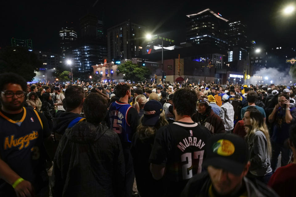 People celebrate after the Denver Nuggets won the NBA Championship with a victory over the Miami Heat in Game 5 of basketball's NBA Finals, Monday, June 12, 2023, in Denver. (AP Photo/David Zalubowski)