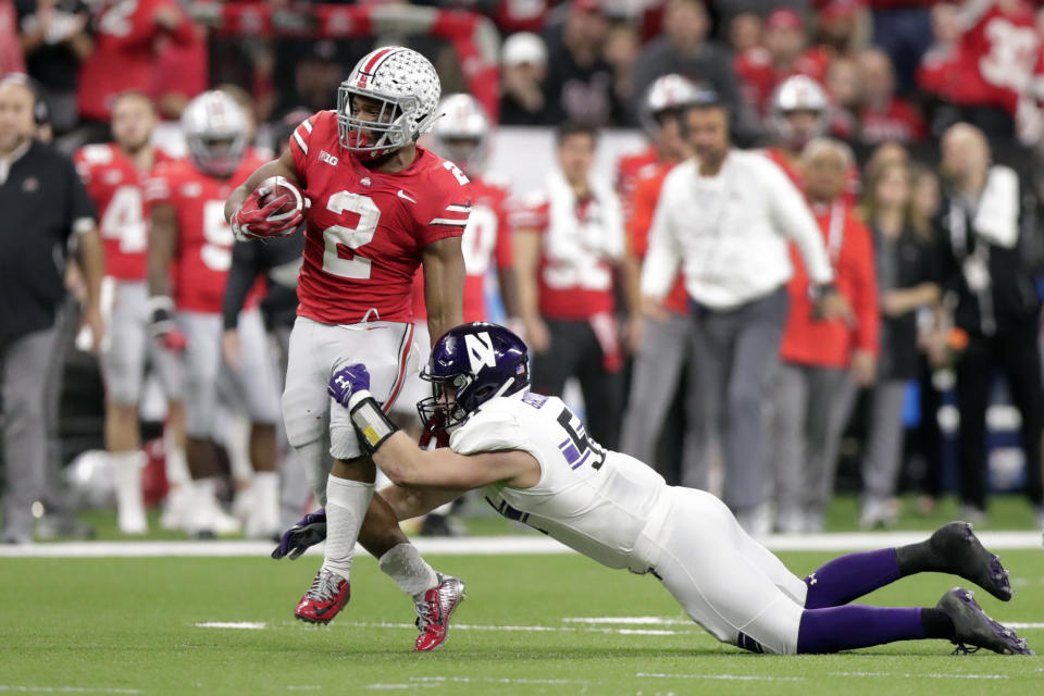 Ohio State running back J.K. Dobbins (2) is tackled by Northwestern linebacker Blake Gallagher during the first half of the Big Ten championship NCAA college football game, Saturday, Dec. 1, 2018, in Indianapolis. (AP Photo/Michael Conroy)