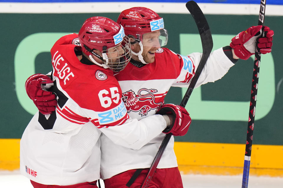 Denmark's Frederik Storm, right, celebrates with Denmark's Christian Wejse after scoring his sides second goal during the preliminary round match between Austria and Denmark at the Ice Hockey World Championships in Prague, Czech Republic, Saturday, May 11, 2024. (AP Photo/Petr David Josek)