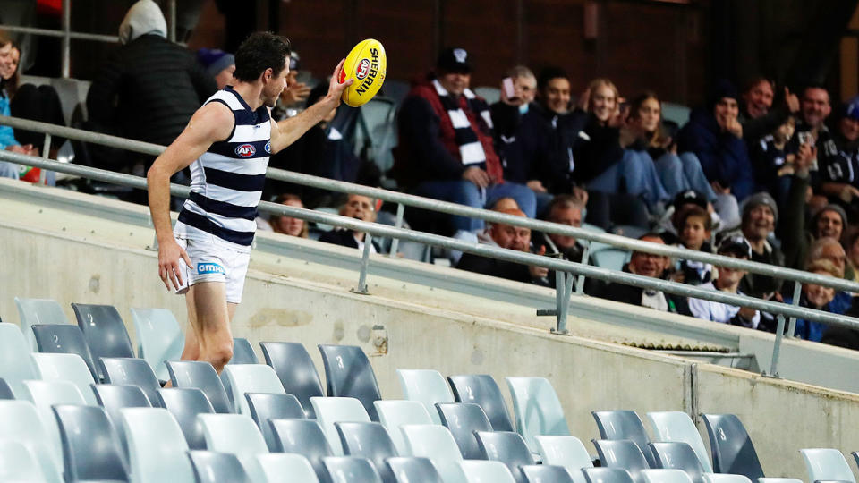 Isaac Smith, pictured here collecting the ball from over the fence during Geelong's clash with Western Bulldogs at GMHBA Stadium.