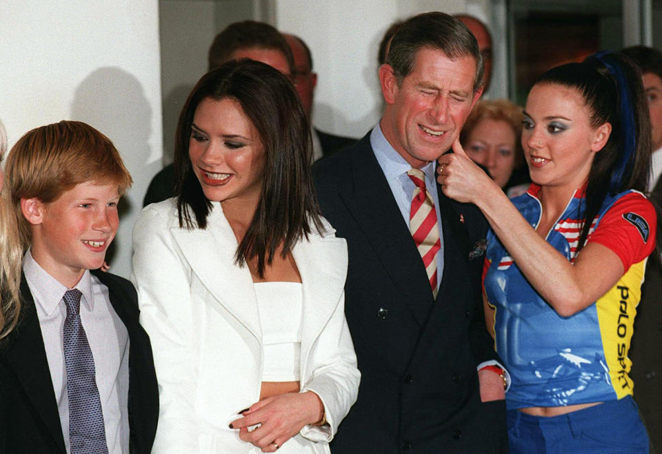 Prince Harry (left) poses with Spice Girls Victoria (2nd left) while his father, His Royal Highness Prince Charles (2nd right), catches the attention of Spice Girls Mel C (right) before the British pop group's concert in Johannesburg on November 1. Prince Harry, son of the late Princess Diana, is accompanying his father, the Prince of Wales, on a week-long visit to South Africa. (Photo by WALTER DHLADHLA / AFP) (Photo by WALTER DHLADHLA/AFP via Getty Images)