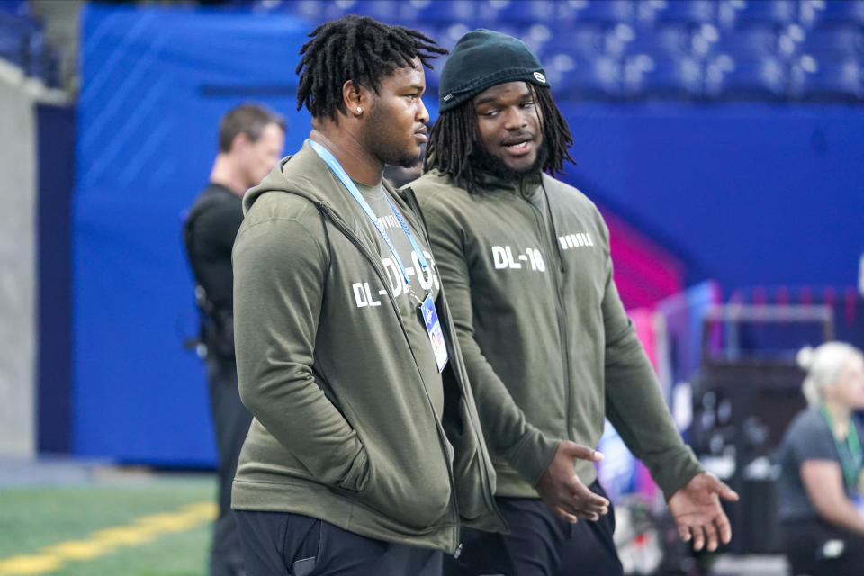 Georgia defensive lineman Jalen Carter, left, talks to Michigan defensive lineman Mazi Smith as players arrive on the field before the NFL football scouting combine in Indianapolis, Thursday, March 2, 2023. (AP Photo/Darron Cummings)