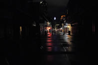 A small stretch of Bourbon Street that has power is seen from an otherwise darkened French Quarter in New Orleans, Wednesday, Oct. 28, 2020. Hurricane Zeta passed through today leaving much of the city and metro area without power. (AP Photo/Gerald Herbert)