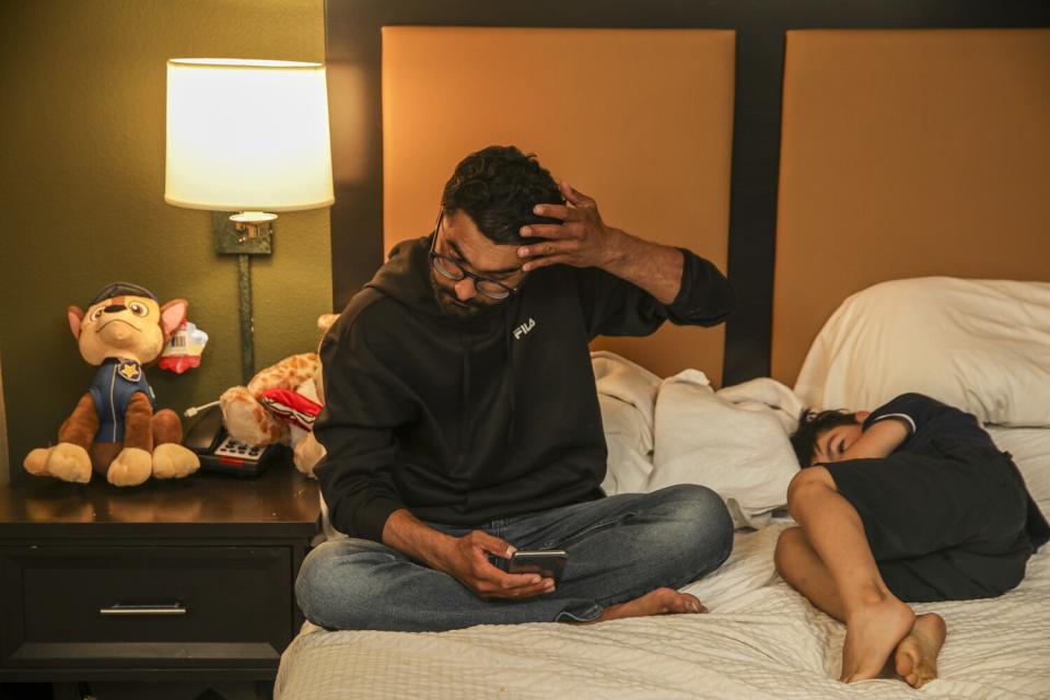 Zabih Khan and his brother Mojib on a bed during a video call.