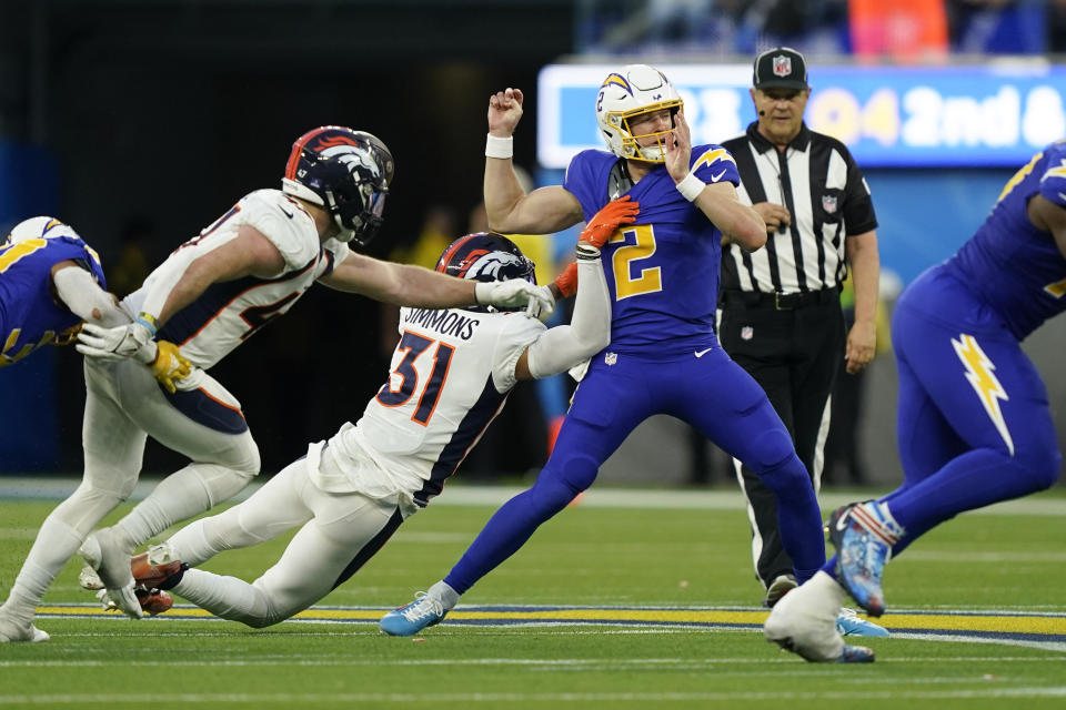 Los Angeles Chargers quarterback Easton Stick (2) fumbles the ball as Denver Broncos safety Justin Simmons (31) sacks him during the second half of an NFL football game Sunday, Dec. 10, 2023, in Inglewood, Calif. (AP Photo/Ryan Sun)