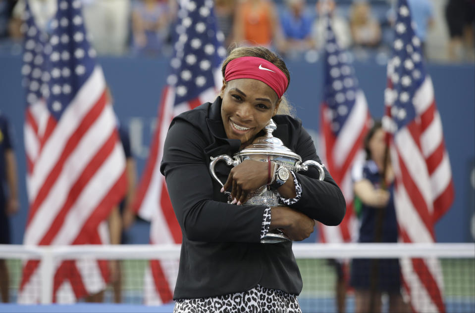 File-This Sept. 7. 2014, file photo shows Serena Williams, of the United States, hugging the championship trophy after defeating Caroline Wozniacki, of Denmark, during the championship match of the 2014 U.S. Open tennis tournament, in New York. Williams has been voted the AP Female Athlete of the Decade for 2010 to 2019. Williams won 12 of her professional-era record 23 Grand Slam singles titles over the past 10 years. No other woman won more than three in that span. She also tied a record for most consecutive weeks ranked No. 1 and collected a tour-leading 37 titles in all during the decade. Gymnast Simone Biles finished second in the vote by AP member sports editors and AP beat writers. Swimmer Katie Ledecky was third, followed by ski racers Lindsey Vonn and Mikaela Shiffrin. (AP Photo/Darron Cummings, File)