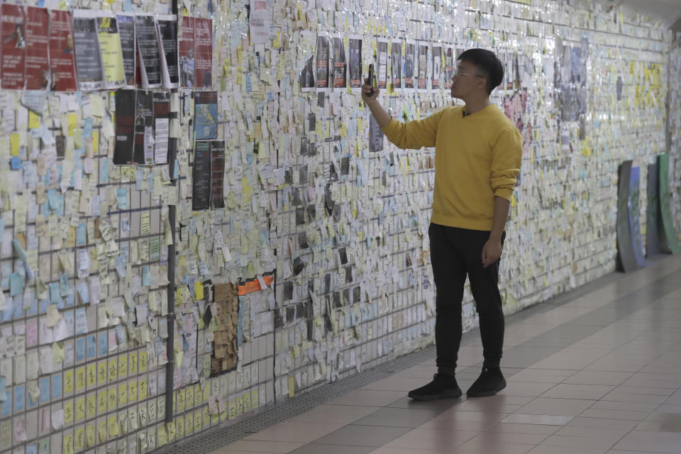 Hong Tsun-ming, a Taiwanese of Hong Kong descent, reads the messages on the post-it notes on the Lennon Wall in Taichung city, Central Taiwan, on Nov. 30, 2023. As Taiwan’s presidential election approaches, many immigrants from Hong Kong, witnesses to the alarming erosion of civil liberties at home, are supporting the ruling Democratic Progressive Party.(AP Photo/Chiang Ying-ying)