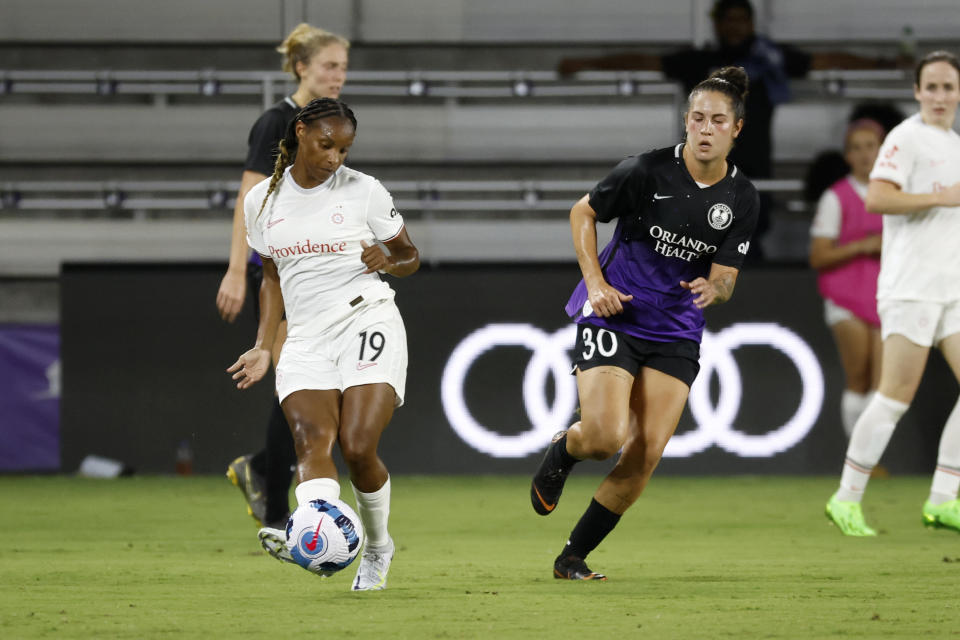 Sep 9, 2022; Orlando, Florida, USA; Portland Thorns FC midfielder Crystal Dunn (19) plays the ball with Orlando Pride midfielder Thais Reiss (30) defending during the second half at Exploria Stadium. Mandatory Credit: Kim Klement-USA TODAY Sports