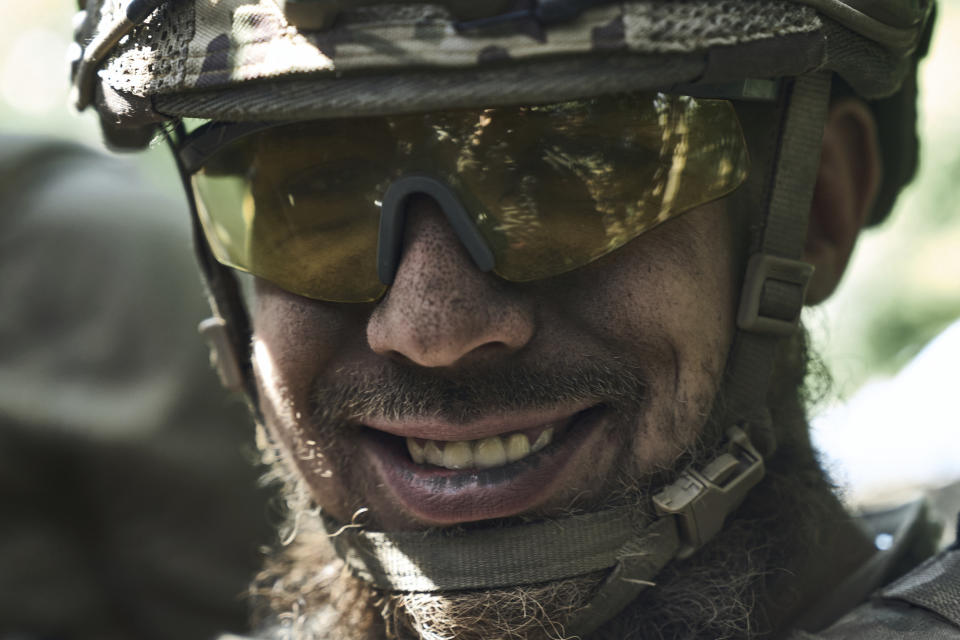 A soldier of Ukraine's 3rd Separate Assault Brigade smiles near Bakhmut, the site of fierce battles with the Russian forces in the Donetsk region, Ukraine, Sunday, Sept. 3, 2023. (AP Photo/Libkos)