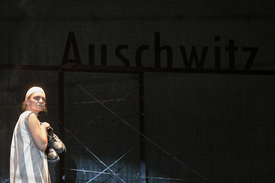 Alexandra Fasola of the Jewish State Theatre performs during the premiere of the "The Beautiful Days of My Youth" play, based on the diary of Romanian Jewish Holocaust survivor Ana Novac, in Bucharest, Friday, Oct. 16, 2020. Maia Morgenstern, head of the Jewish State Theater and a Romanian Jewish actress best known for playing Mary in Mel Gibson's controversial 2004 movie "The Passion of the Christ," described the play's staging in an interview with The Associated Press as an "all-feminine project." (AP Photo/Andreea Alexandru)