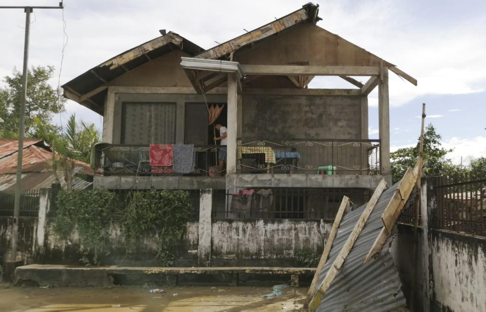 A resident checks his home damaged by Typhoon Phanfone in Ormoc city, central Philippines on Thursday Dec. 26, 2019. The typhoon left over a dozen dead and many homeless. (AP Photo)