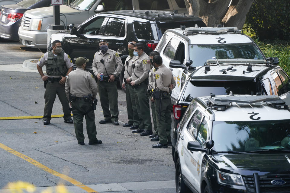 FILE - Police officers stand outside St. Francis Medical Center on Sept. 14, 2020, in Lynwood, Calif. after two Los Angeles County Sheriff's deputies were shot in an apparent ambush. Recent shootings of police officers and protests that have left scores of officers injured are stark reminders of the dangers facing law enforcement around a country grappling with police killings of African Americans.(AP Photo/Ashley Landis, File)