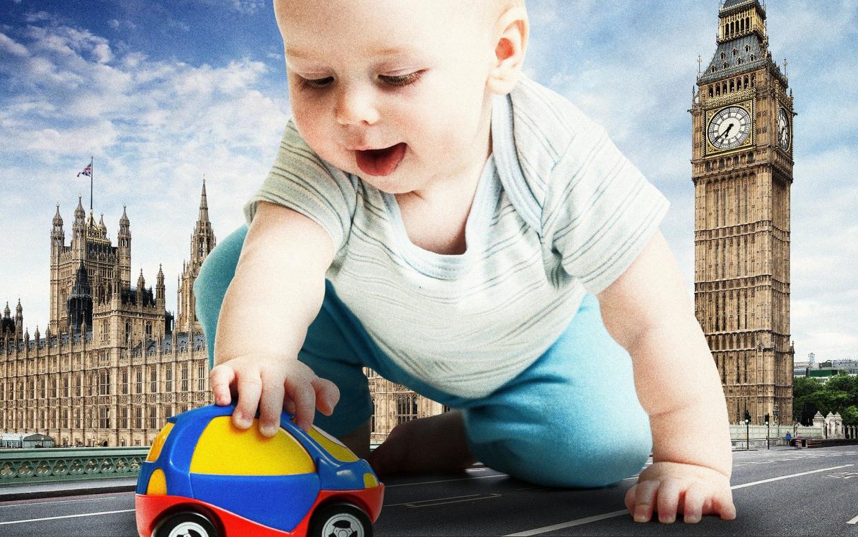 Baby playing with a toy car in front of Parliament