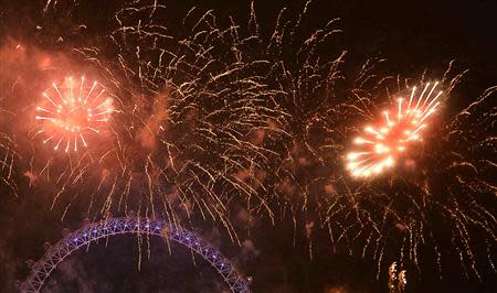 Fireworks explode around the London Eye wheel during New Year celebrations in central London January 1, 2014. REUTERS/Toby Melville